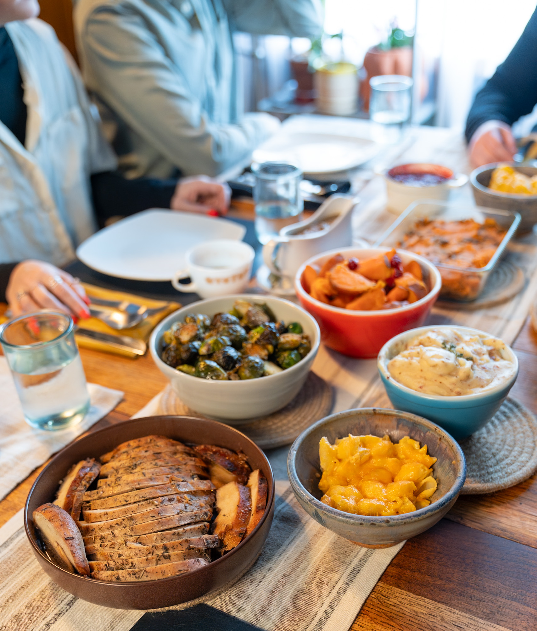 A holiday spread of sides, rolls, and pumpkin pie